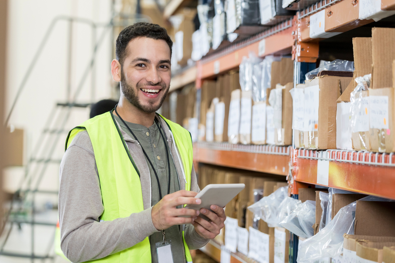 Warehouse employee checks warehouse inventory